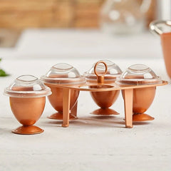 Stainless Steel Egg Ring Mold - Copper-toned egg poacher set arranged on a light stone kitchen countertop