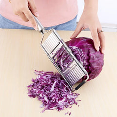 Vegetable Cutter - Slicer in use shredding purple cabbage on a wooden countertop