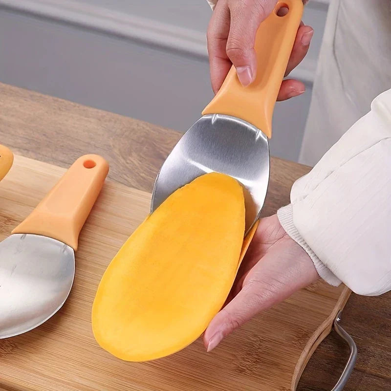 Mango slicer being positioned along a halved mango, with additional mango slicers resting on a bamboo cutting board