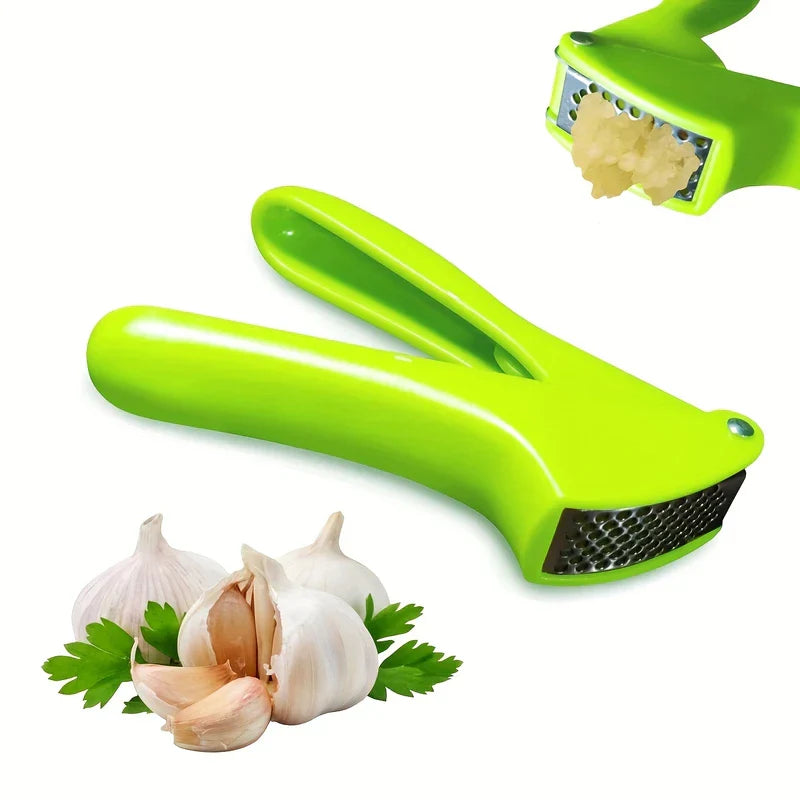 Garlic Press Rocker - Bright green kitchen mincing tool shown with whole and split garlic bulbs and fresh parsley, with minced garlic visible exiting the perforated pressing plate