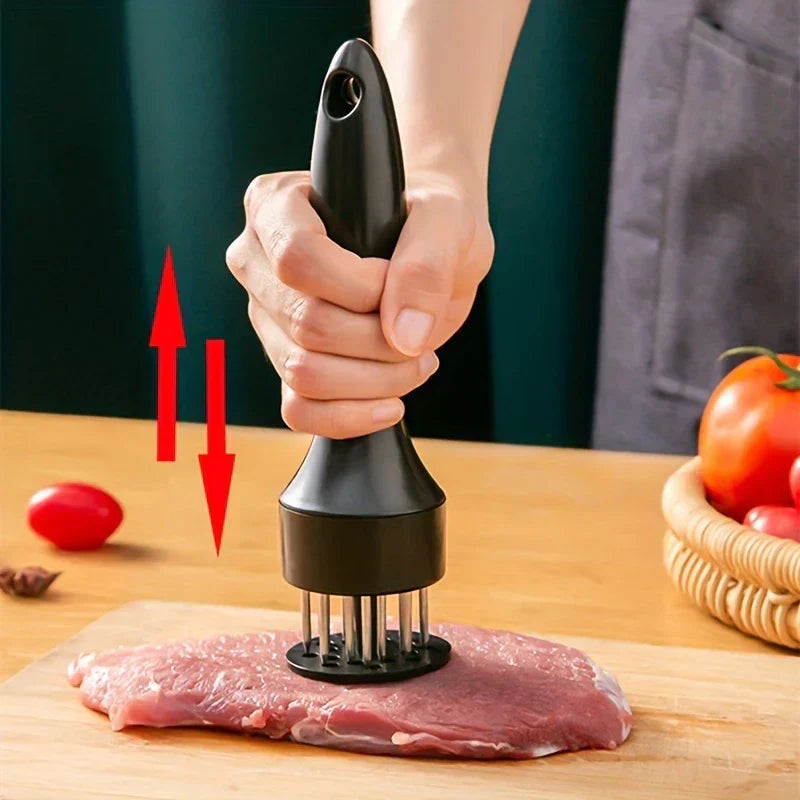 Stainless Steel Meat Tenderizer - Hand holding black meat tenderizer, pressing prongs into a raw steak on a wooden cutting board