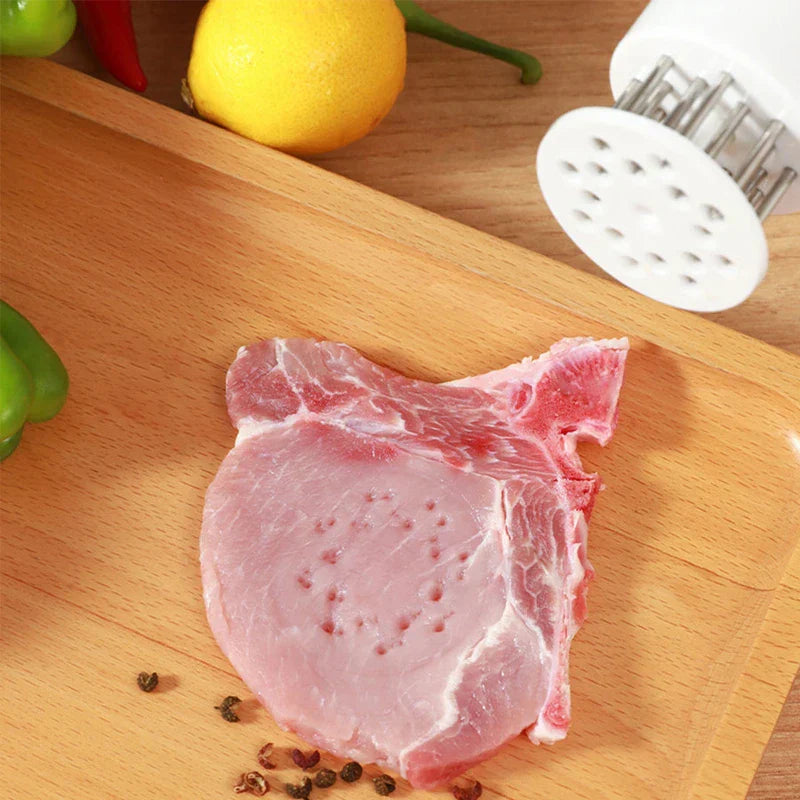 Stainless Steel Meat Tenderizer - Raw pork chop on a wooden tray with spices, produce, and a meat tenderizer tool nearby