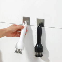 Stainless Steel Meat Tenderizer - White and black handled meat tenderizers hanging from adhesive wall hooks, with a hand holding the white one