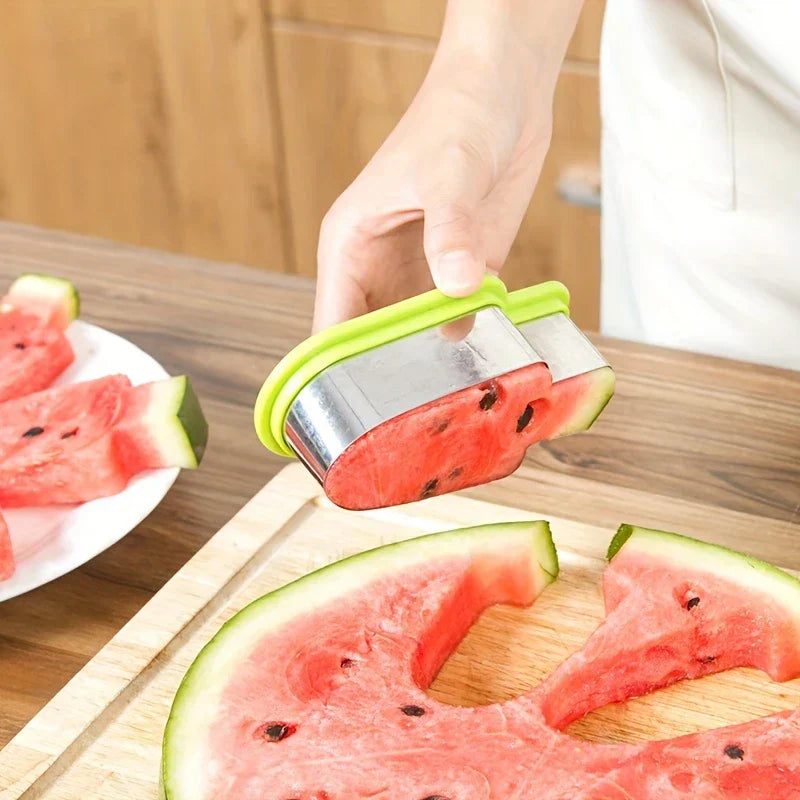 Watermelon Slicer Cutter - Hand pressing the cutter into a halved watermelon on a wooden cutting board, with cut slices on a nearby plate