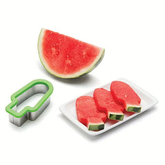 Watermelon Slicer Cutter - Cutter placed next to a whole watermelon wedge and a plate of finished popsicle-shaped watermelon slices