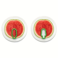 Watermelon Slicer Cutter - Two small popsicle-shaped cutters placed on round watermelon slices on two separate white plates
