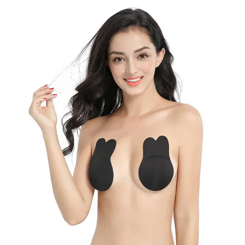 Nipple Concealers - Smiling woman wearing black bunny-style nipple covers, holding a thin strand