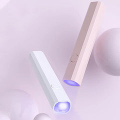 White and pink undercabinet led strip lighting units emitting purple light, angled on soft purple background