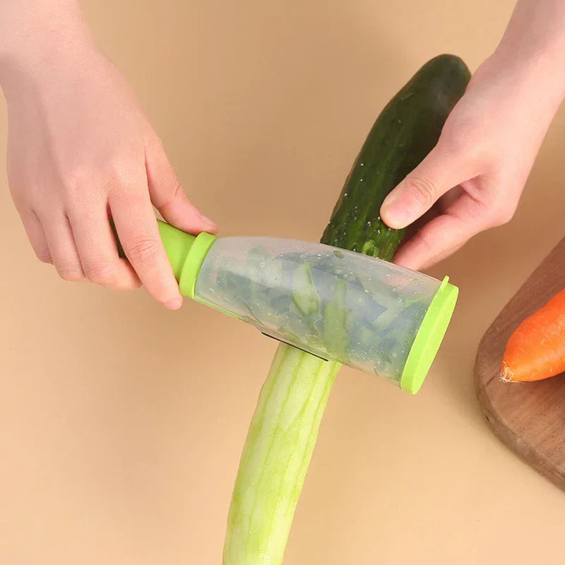 Storage Grater Box Container - Two hands using the green storage peeler on a cucumber, with peeled skin collected inside the peeler.