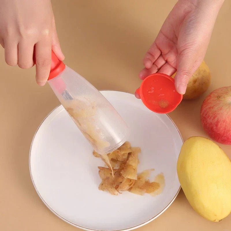 Storage Grater Box Container - Hands empty collected fruit and vegetable peels from a storage peeler onto a white plate beside a potato, mango and apple