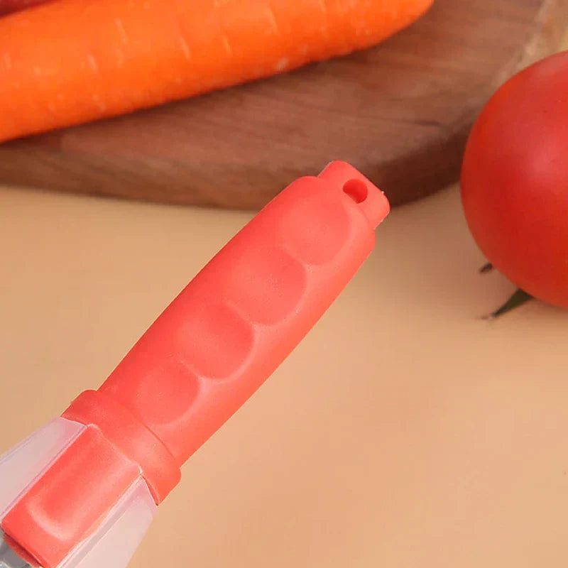 Storage Grater Box Container - Close-up of a red handled storage peeler with a carrot and tomato on a wood board in background