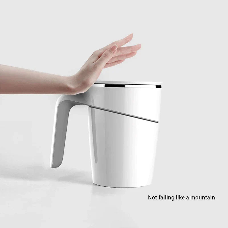 Suction Bottom No Spill Tumbler Cup Mug - Hand pushing white lidded mug to show it stays upright, with "Not falling like a mountain" text at bottom