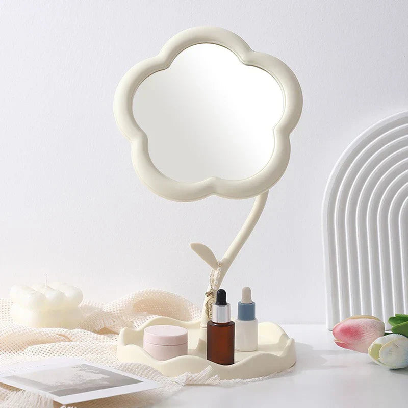 Makeup Mirror - Cream flower-shaped desktop vanity mirror with integrated petal-edge tray holding small skincare containers, styled on a white surface