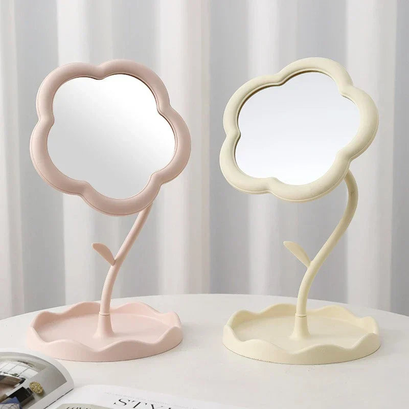 Makeup Mirror - Two flower desktop mirrors, one pink one cream, placed side by side on a white table against a striped curtain
