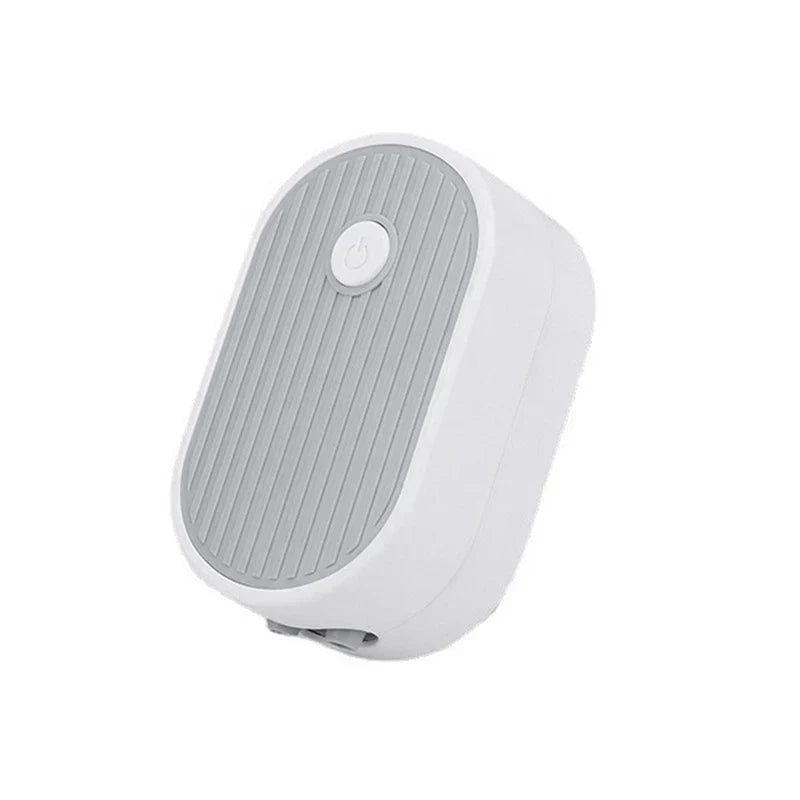 Tea Tray Drainage Pipe - Compact white and gray oval device with ribbed top panel and centered power button