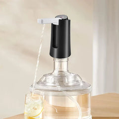 Electric Water Bottle Pump - Unit installed on a clear water jug dispensing water into a glass with lemon slices