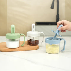 Telescopic Extendable Seasoning Spoon - Three color variants of sealed seasoning jars with retractable spoons holding salt, Sichuan peppercorns, and bouillon granules on a kitchen counter