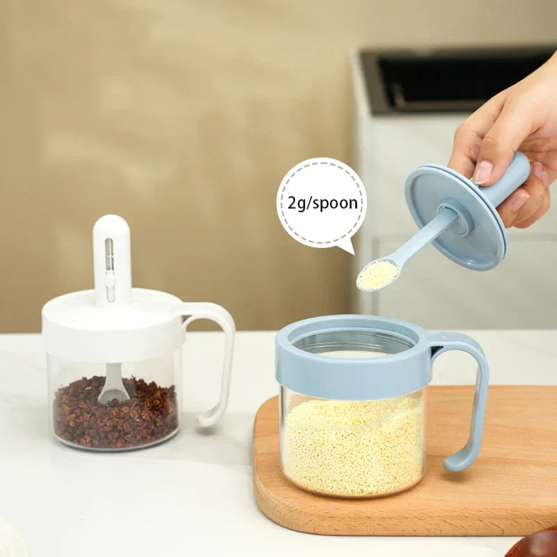 Telescopic Extendable Seasoning Spoon - Light blue retractable spoon lifted from seasoning jar, showing 2g portion of granulated seasoning