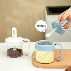 Telescopic Extendable Seasoning Spoon - Light blue retractable spoon lifted from seasoning jar, showing 2g portion of granulated seasoning
