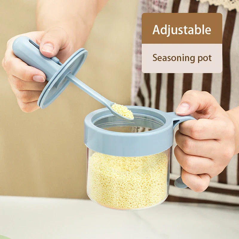 Telescopic Extendable Seasoning Spoon - Two hands hold an adjustable seasoning pot's lid and jar; the integrated spoon holds yellow granular seasoning.