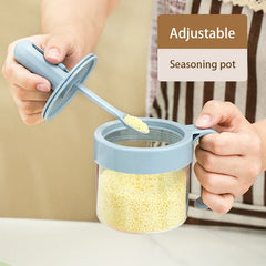 Telescopic Extendable Seasoning Spoon - Two hands hold an adjustable seasoning pot's lid and jar; the integrated spoon holds yellow granular seasoning.