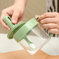 Telescopic Extendable Seasoning Spoon - Two hands open a green seasoning jar: the lid is removed, the integrated spoon holds white granular contents inside the clear jar.
