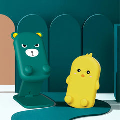 Folding Phone Stand - Teal bear and yellow chick design stands displayed side by side on a styled teal and white set