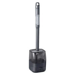 Toilet brush with long dark handle and attached translucent gray storage holder, upright on white background