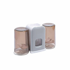 Rinse Cup - Freestanding two-cup bathroom organizer set with gray and white central base and amber translucent cups