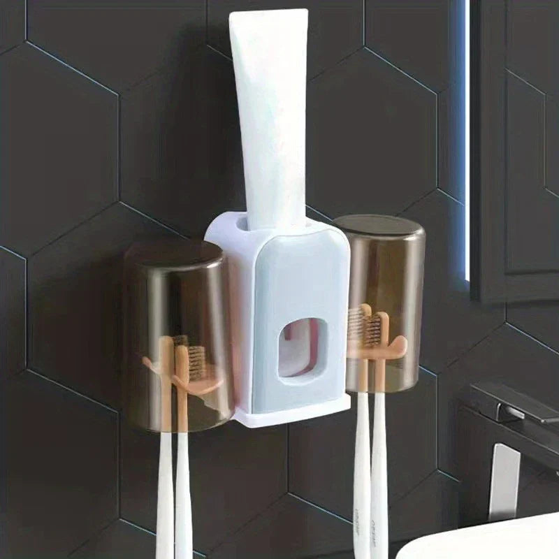 Rinse Cup - Wall-mounted toothbrush holder with two inverted cups, four toothbrushes, and an inserted toothpaste tube