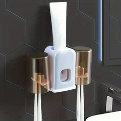 Rinse Cup - Wall-mounted toothbrush holder with two inverted cups, four toothbrushes, and an inserted toothpaste tube