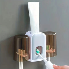 Rinse Cup - Wall-mounted organizer holding toothpaste, with electric toothbrush positioned at the built-in toothpaste dispenser and manual toothbrushes stored under covered cups