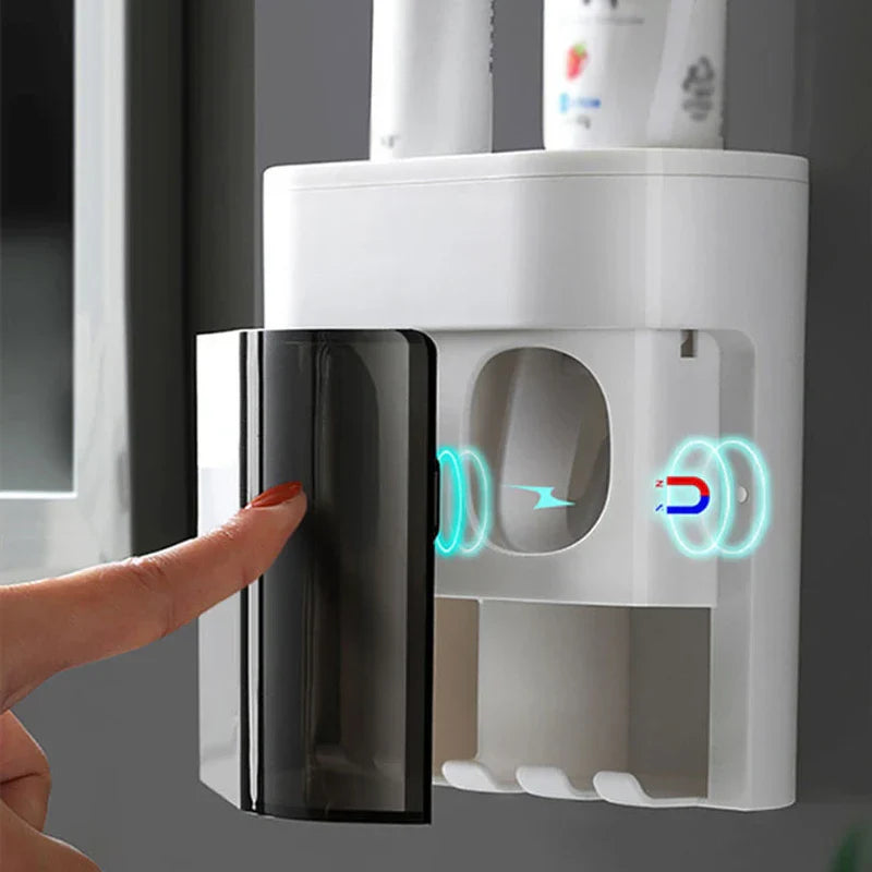 A finger opens a magnetic transparent door on a white bathroom wall organizer, toothpaste dispenser squeezer is not clearly visible.