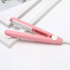 Sealing Tool - Open light pink mini hair straightener resting on a white stepped surface
