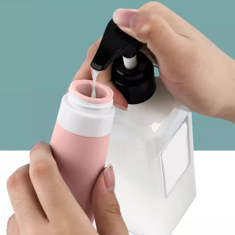 Travel Toiletry Bottles Set - Hands pouring white liquid from a black pump bottle into a pink travel bottle.