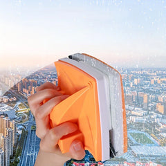 Window Cleaner - Hand holding the double-sided cleaning tool against glass with a city skyline visible through the surface