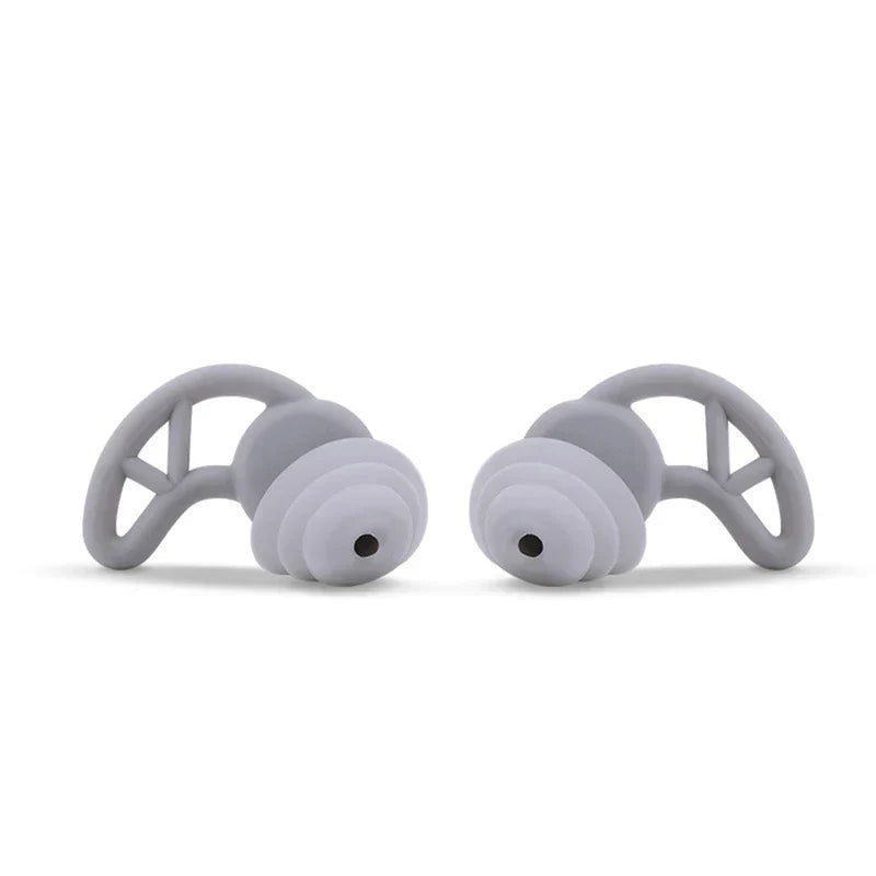 Noise Cancelling Ear Plugs - Pair of light gray triple flange ear plugs with stabilizing ear wings, front view on white background