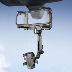Black flexible gooseneck phone holder mounted on a car rearview mirror against a sky background.