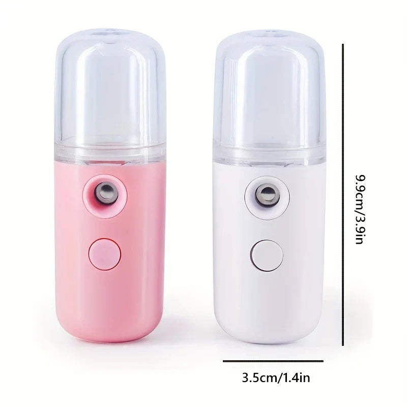 Pink and white USB nano facial misters side by side, each 9.9cm/3.9in tall, 3.5cm/1.4in wide on white background.