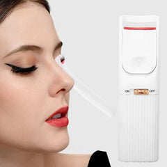 Heated eyelash curler in use