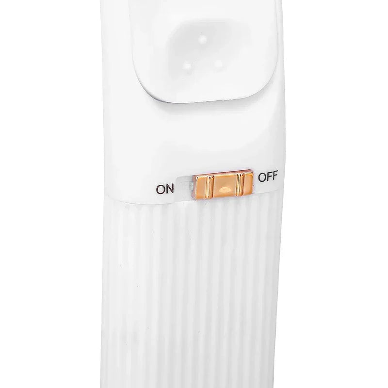 Heated Eyelash Curler - Close-up of the gold ON/OFF sliding switch on a white ribbed handheld device