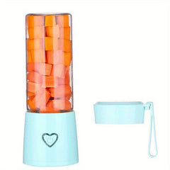 Portable Juicer - Portable blender with cut carrot pieces inside its cup, lid removed and placed beside the base