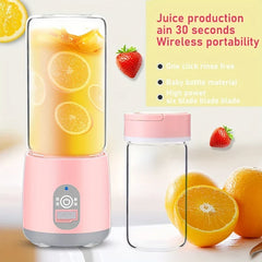 Portable Juicer - Pink portable blender with orange liquid and slices inside, shown with an extra empty cup and nearby fruit