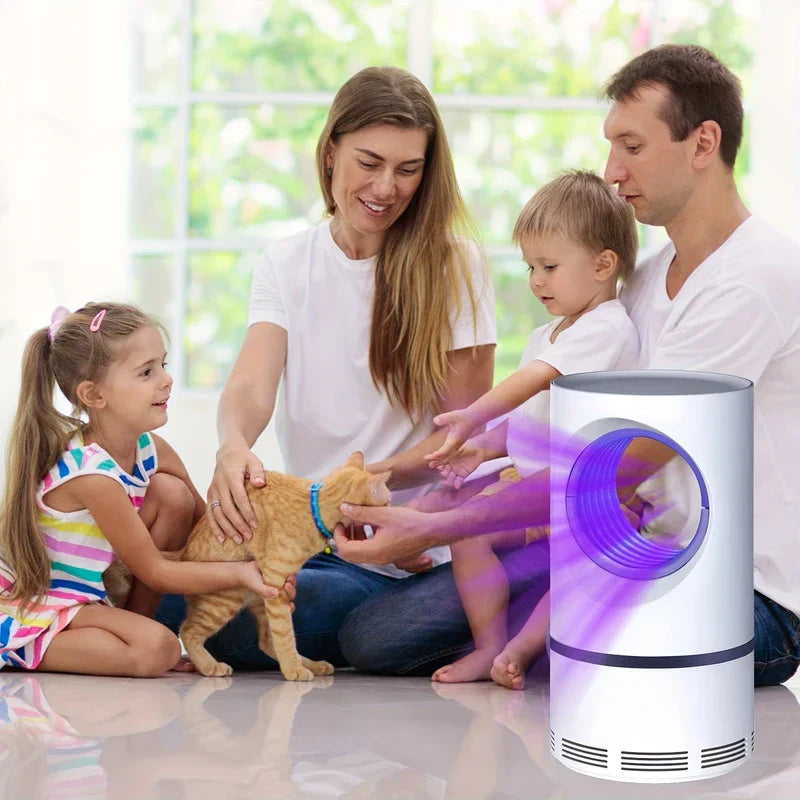 Bug Zapper - White cylindrical mosquito trap with purple light placed on a floor beside a family of four with a cat