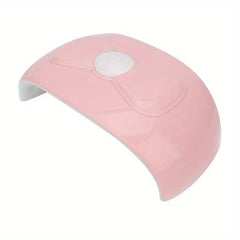Nail Dryer - Light pink glossy curved curing device with white central control button, angled front view against white background