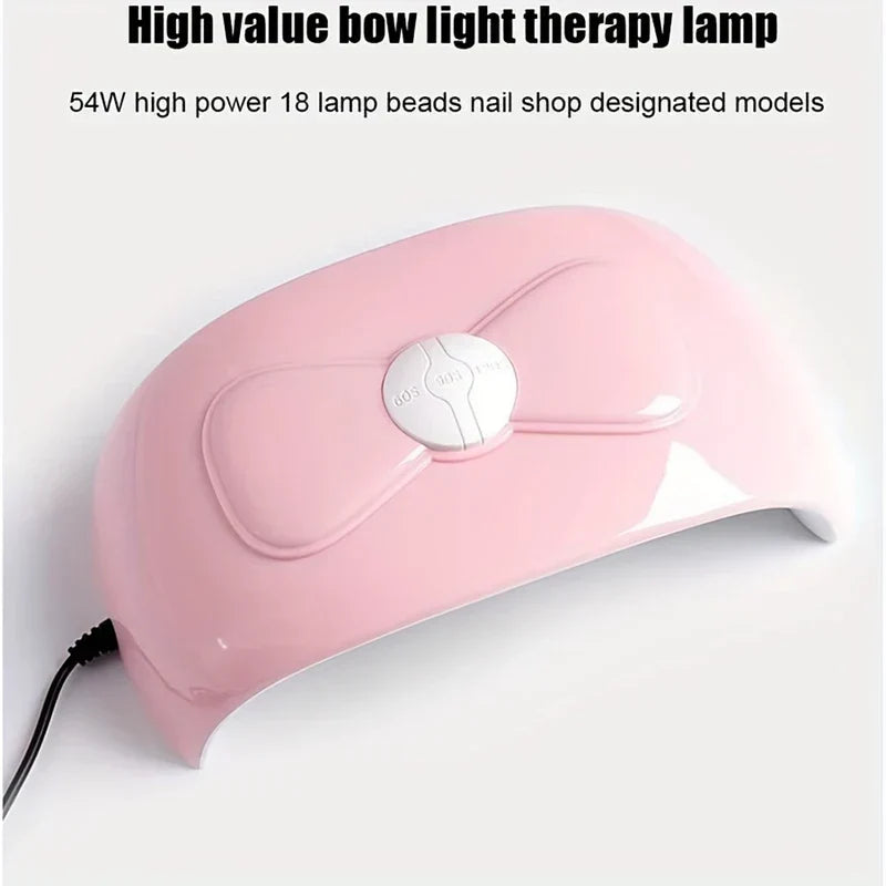 مصباح أظافر uv led - منظر أمامي خارجي لمصباح تجفيف أظافر وردي مع زر تحكم أبيض في المنتصف وسلك طاقة متصل