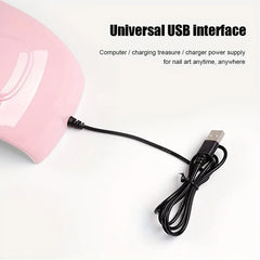 Nail Dryer - Partial view of a pink nail lamp with its coiled attached USB cable, against a plain white background.