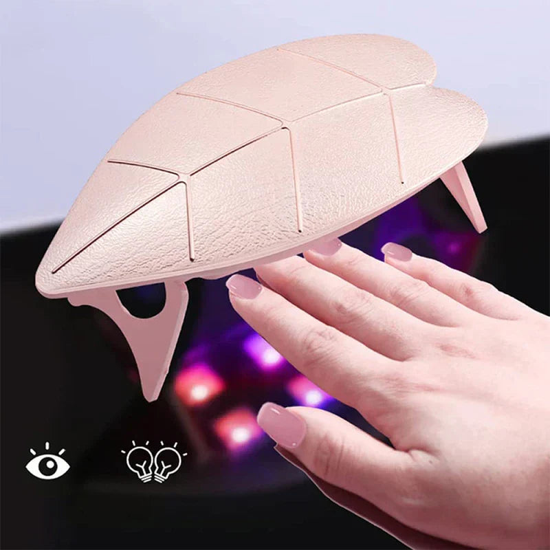Uv Led Nail Lamp - Pink unit in use curing gel polish on a hand, with internal curing lights visible