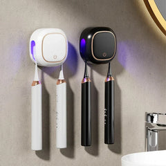 Uv Toothbrush Sanitizer Holder - Two units (white and black) mounted on textured bathroom wall holding electric toothbrushes with active UV light