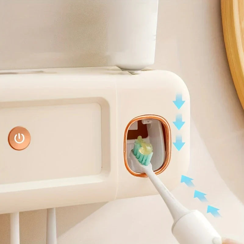 Esterilizador UV para cepillo de dientes: primer plano del dispensador automático de pasta dental dispensando pasta sobre un cepillo, con botón de encendido visible.